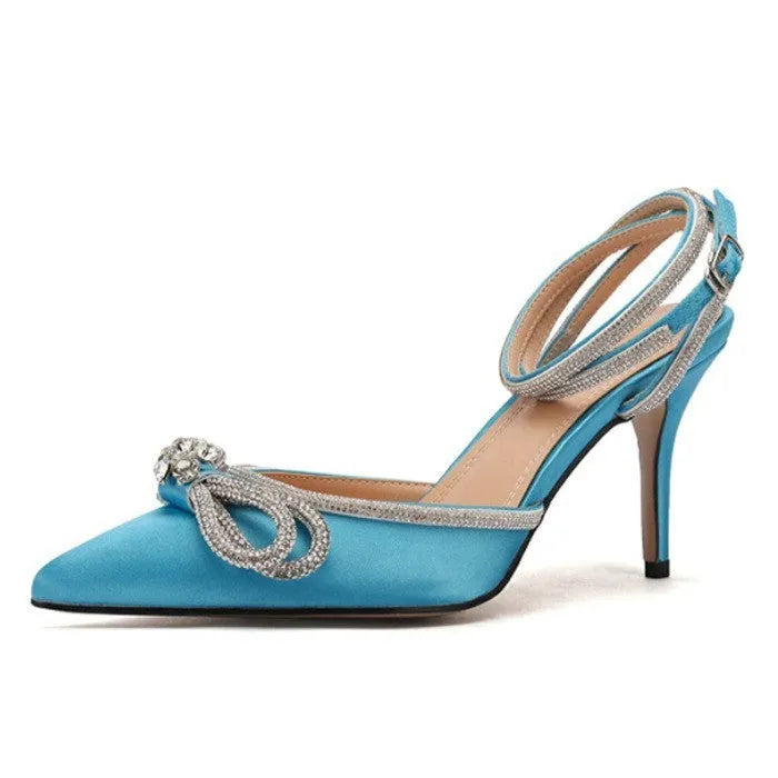 Women's black stiletto heel sandals with a silk bandage wrap back and buckle fastening, showing pointed toe.
