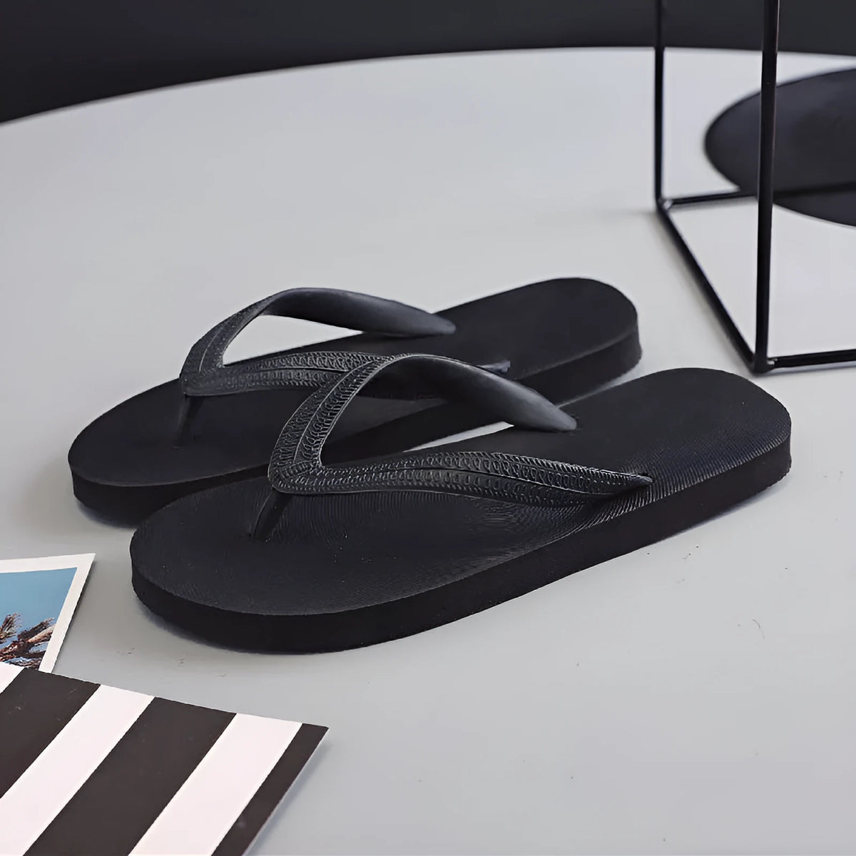 Rubber flip-flops with non-slip, deodorant soles in green, red, blue, or black with a fish logo.