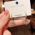 Close-up of a women's geometric rose design zircon earring with an electroplated finish.