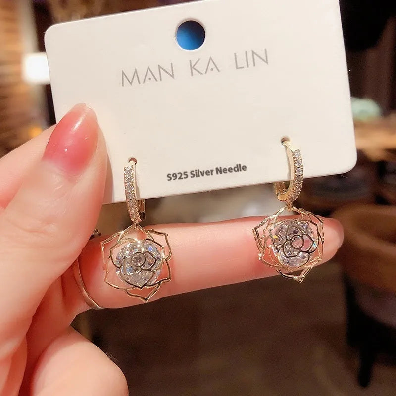 Close-up of a women's geometric rose design zircon earring with an electroplated finish.