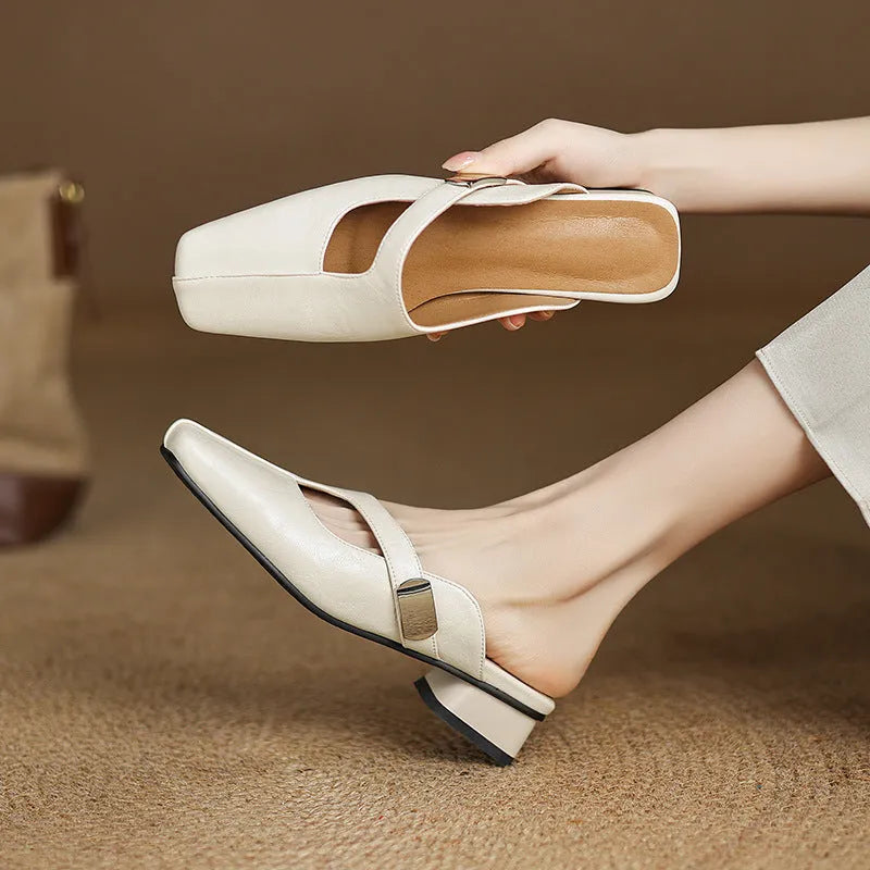 British style square toe leisure slippers in beige with a low heel and rubber sole.