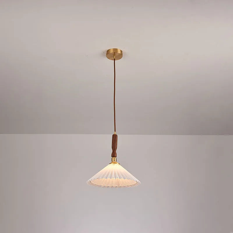 Walnut wood and copper American retro wall lamp with fabric shade on a wall.