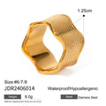 Close-up of a stainless steel geometric wave ring with a wide, sculpted surface.