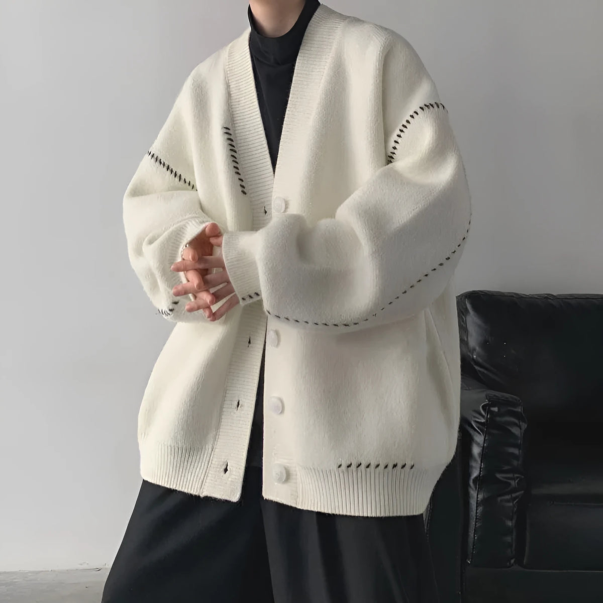 Women's black knitted cardigan top coat with long sleeves and loose fit made from polyester fabric