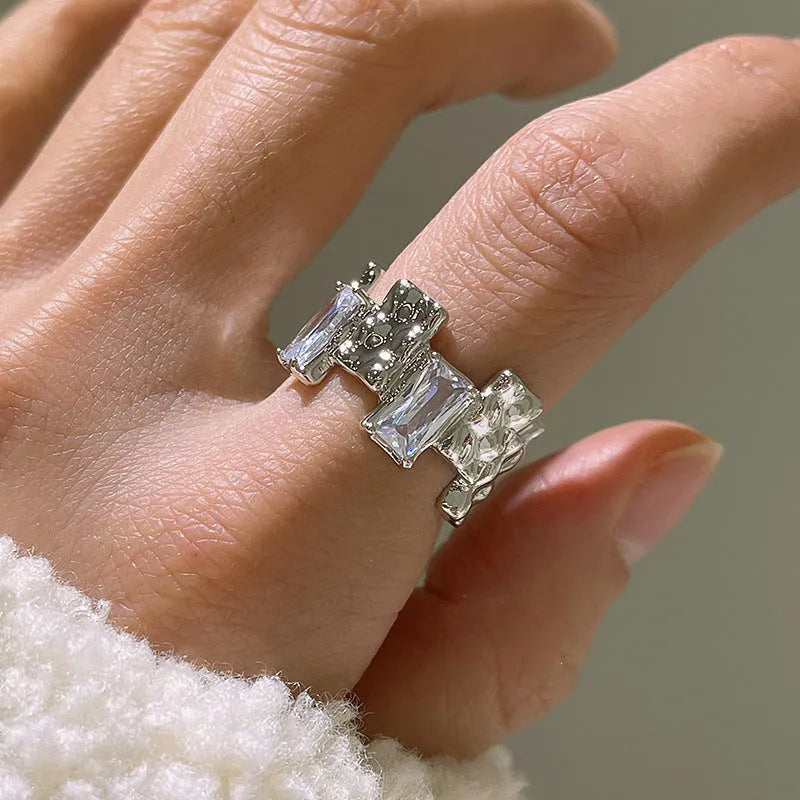 Silver geometric cross ring with open zircon setting and retro design