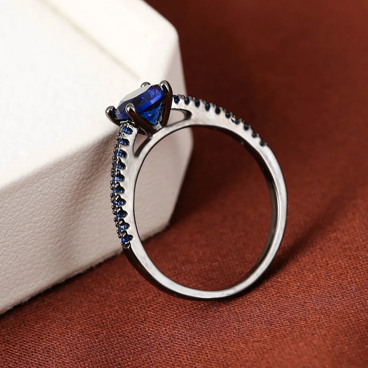 A hexagonal geometric zircon ring in a copper electroplated finish, showing one of the ten available colour options.