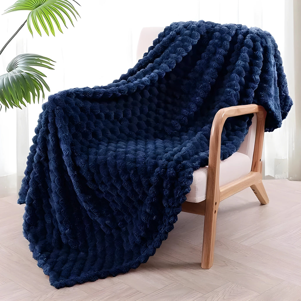 Soft polyester velvet children's plaid blanket in camel colour, shown in a 90x90 inch size on a bed.