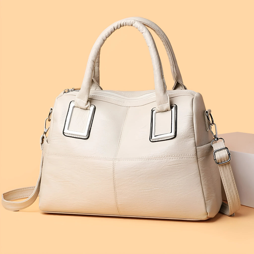 Women's large capacity shoulder bag in horizontal square shape with internal phone and document pockets.