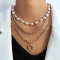 Vintage gold necklace with heart-shaped pendant and pearl chain design