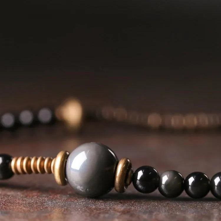Geometric black beaded bracelet with multi-layered construction and colourful detailing