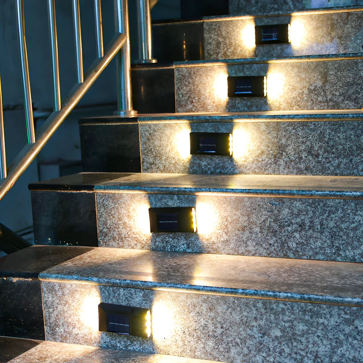 Solar-powered garden wall light mounted on outdoor brick wall illuminating pathway at night
