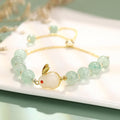 Rabbit charm bracelet with green aventurine and strawberry quartz stones on a gold or copper chain.