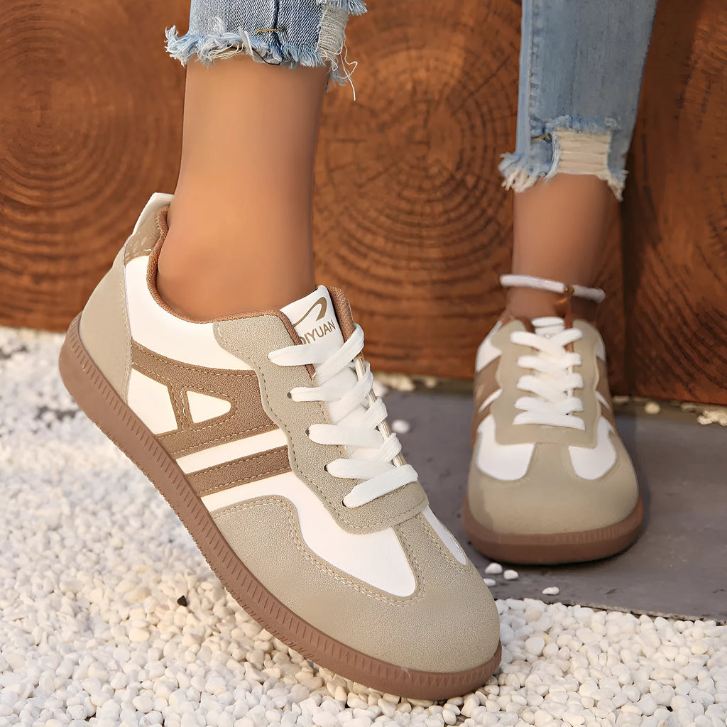 Women's retro lace-up jogging shoes in black, grey, and khaki colours showing round toe and platform heel.