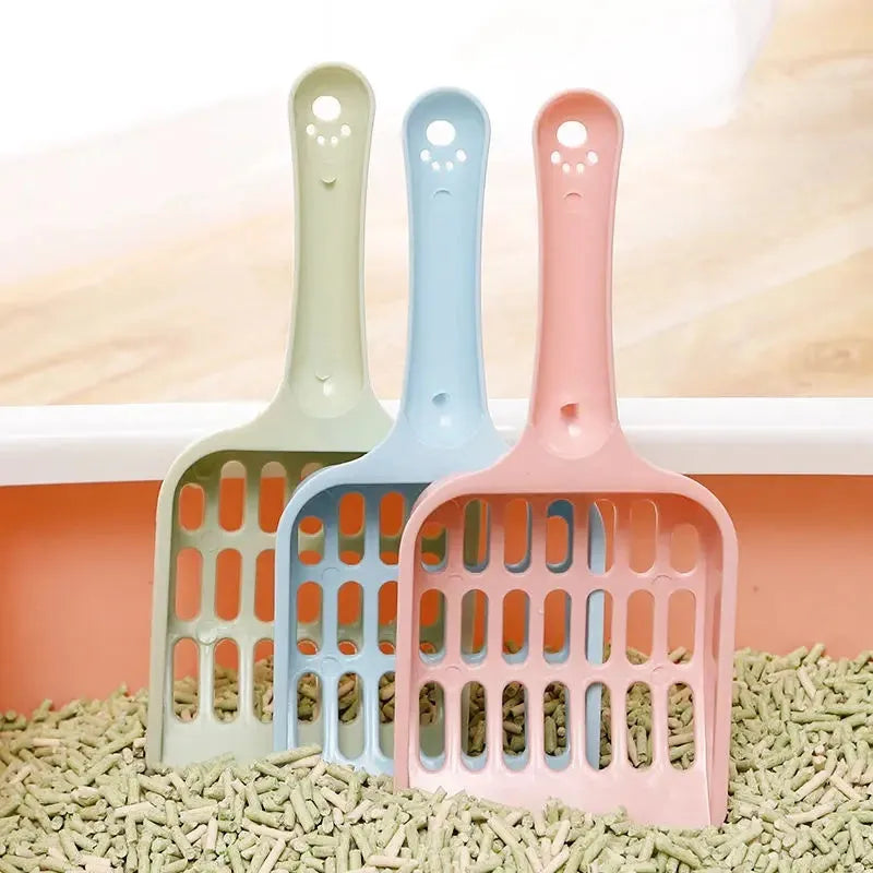 Blue plastic cat litter scoop on a white background.