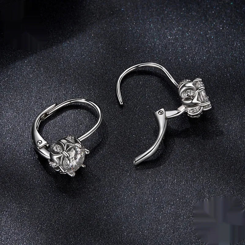 Sterling silver flower bud clip earrings with moissanite stone and white gold plating.