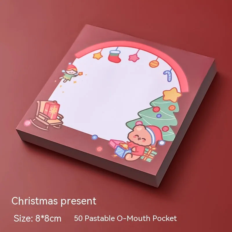 Pad of cartoon Christmas sticky notes showing designs of an elf, gift box, sleigh, and Santa Claus.