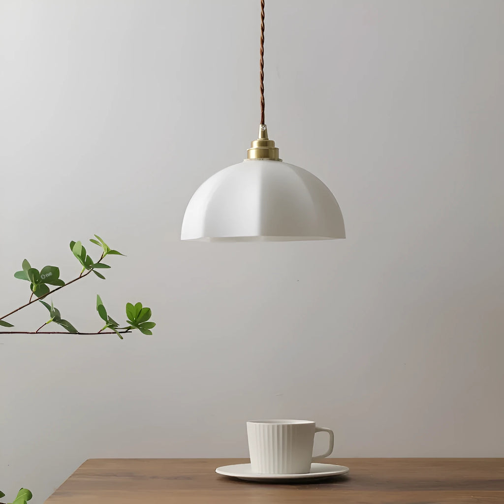 Brass Chinese style pendant light with copper glass shade hanging from ceiling