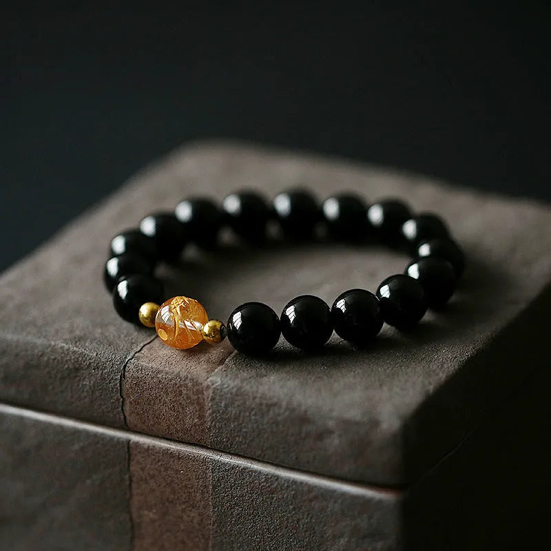 Geometric obsidian and white crystal beaded bracelet with gold dragon charm for 14-16cm wrist.