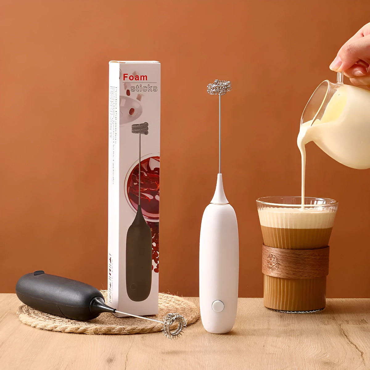 Handheld electric milk frother and blender in modern simple design, shown in black and white colour options.