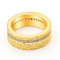 Gold-coloured geometric zircon ring for women on a plain background.