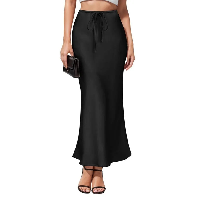 Women's high-waist asymmetric satin skirt in black with irregular stitching detail.