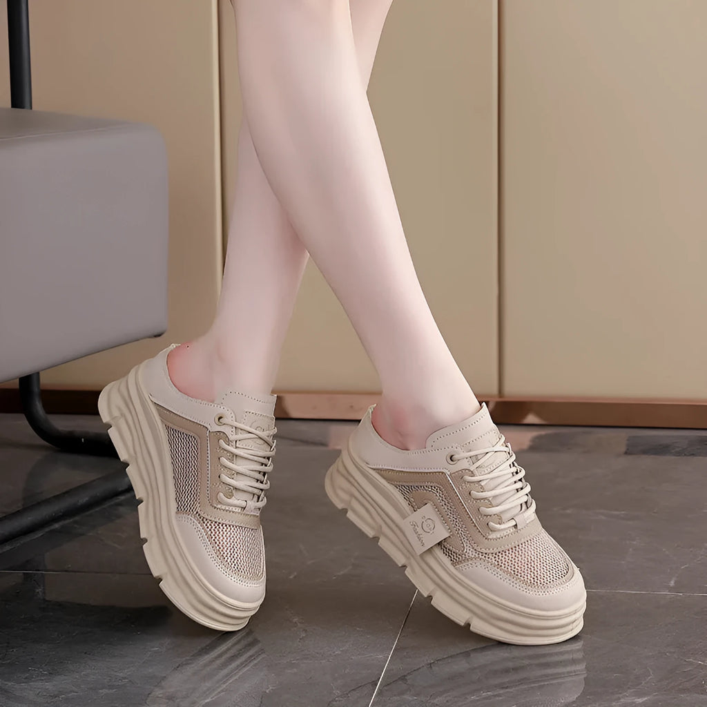 Women's black mesh half slippers with round toe and rubber sole, showing height increasing feature