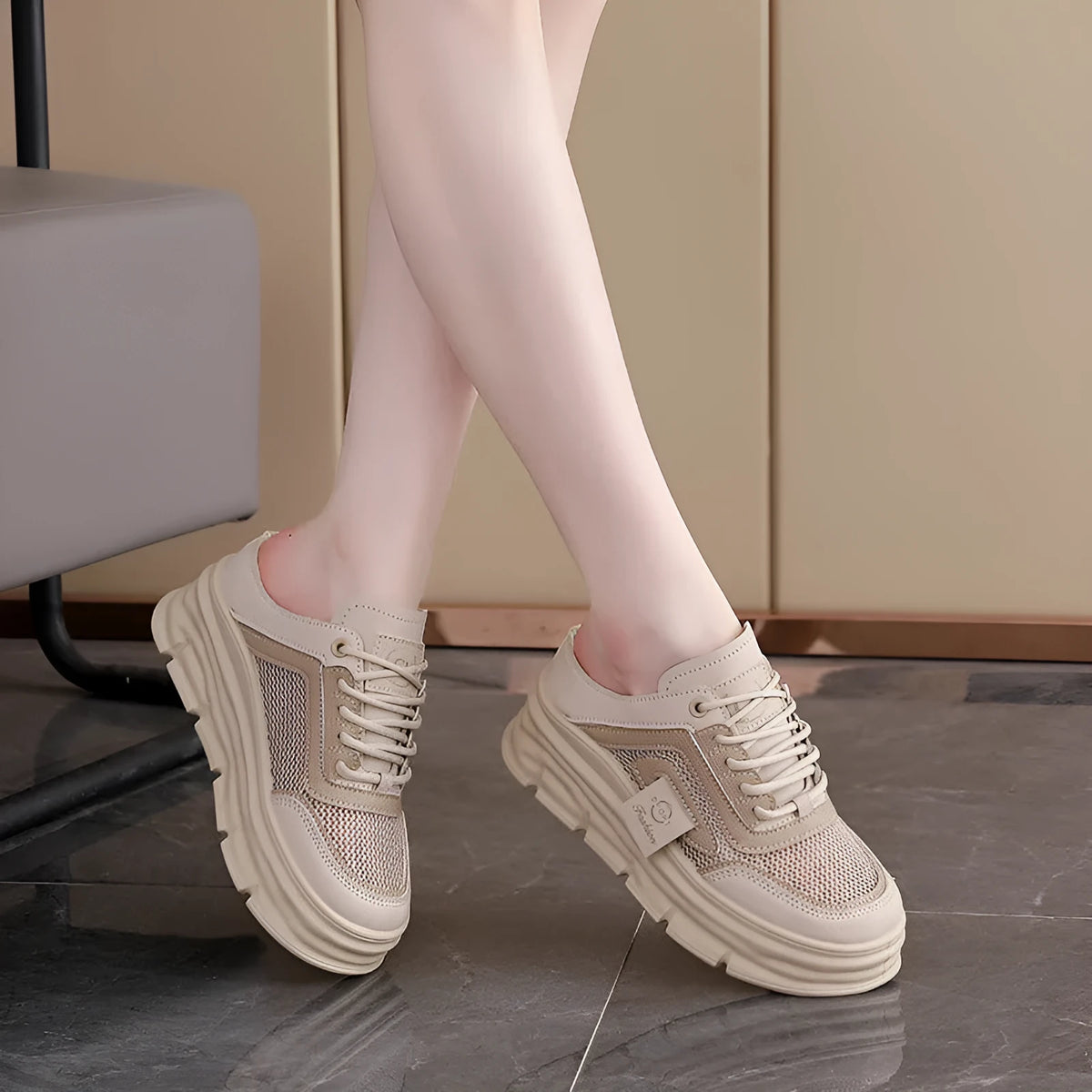 Women's black mesh half slippers with round toe and rubber sole, showing height increasing feature