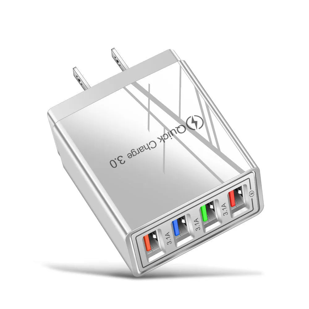 Compact 4-port USB mobile phone charger in multiple colours, shown plugged into a UK wall socket.
