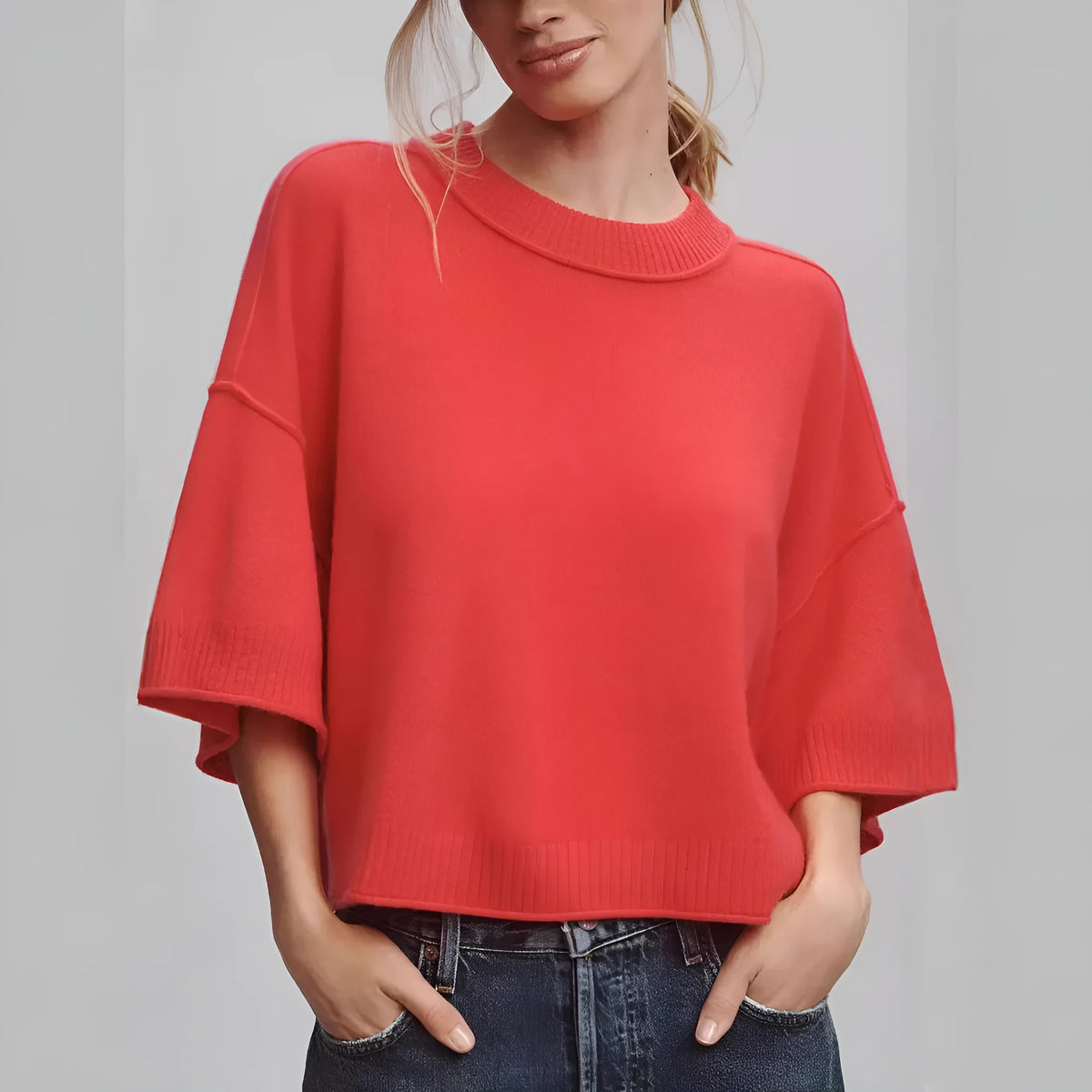 Red cropped viscose t-shirt on a hanger, showing its short length and regular sleeves.