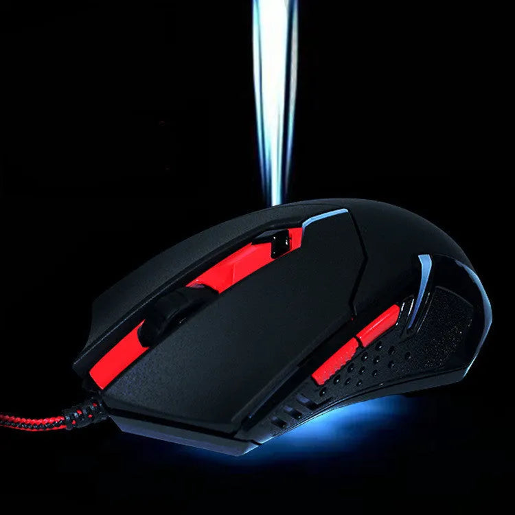Black and red wired USB optical gaming mouse with six buttons on a desk