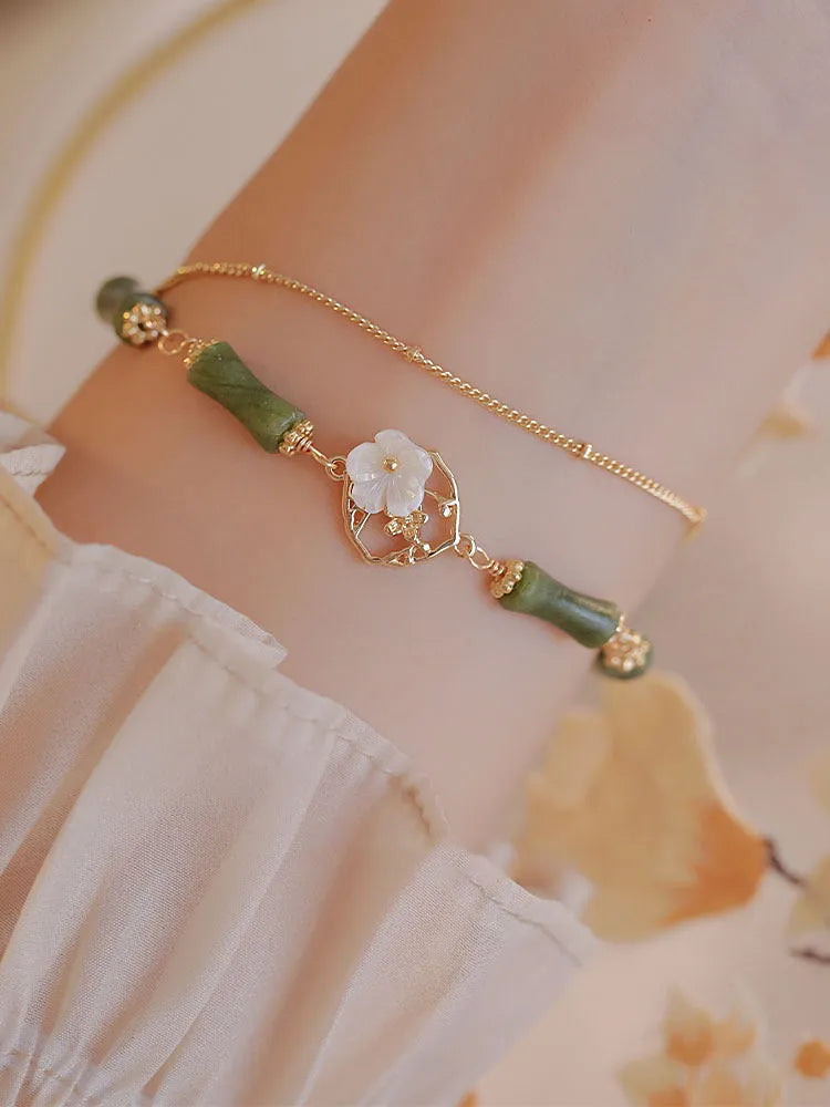 Natural green olivine stone bracelet with double layer Twin Bells of Ireland and Olive Branch design on an adjustable band.