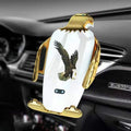 Black and gold wireless charging car phone holder with suction cup mount on a car dashboard.