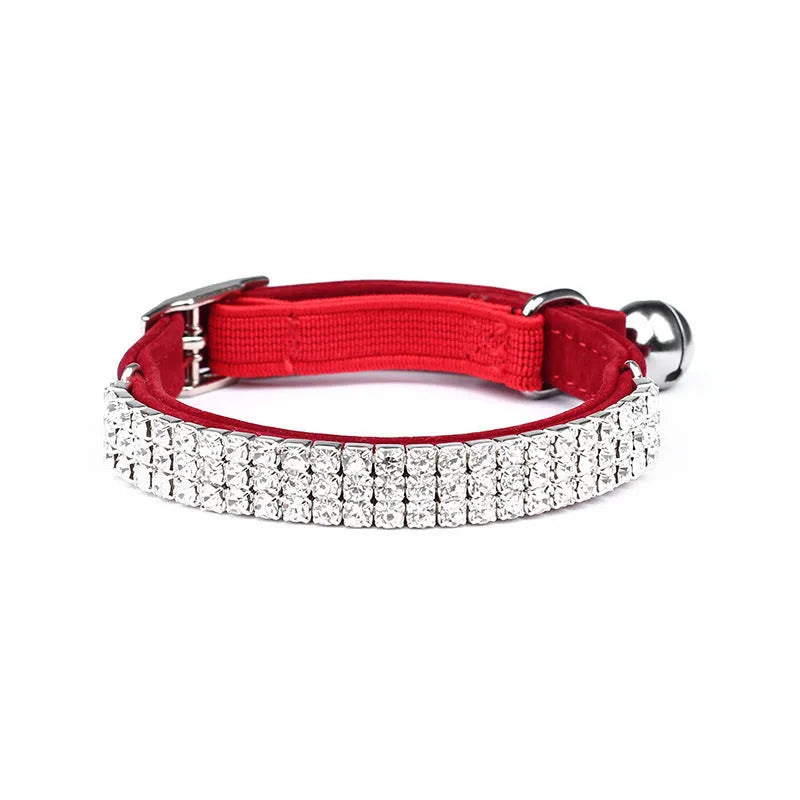 Adjustable black velvet cat collar with a central rhinestone decoration on a white background.