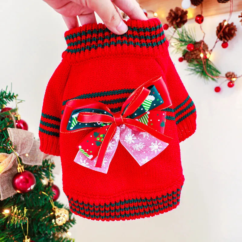 A red polyester Christmas jumper for a dog, showing the festive design and knit fabric.