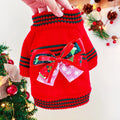 A red polyester Christmas jumper for a dog, showing the festive design and knit fabric.