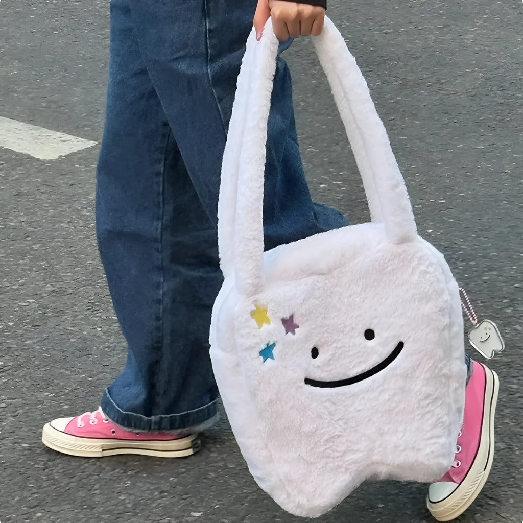 White plush shoulder tote bag with large tooth design and cute teeth pattern, showing zipper closure
