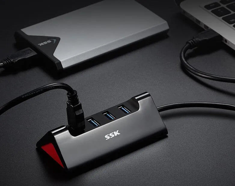 Black USB expansion dock with four ports measuring 100mm by 50mm