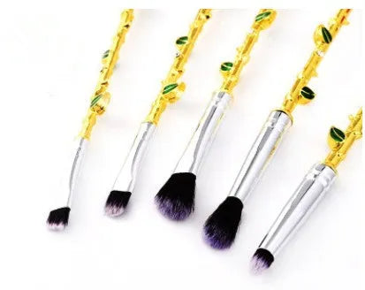 Beauty and the Beast makeup brushes with character-themed bristles and golden or silvery handles