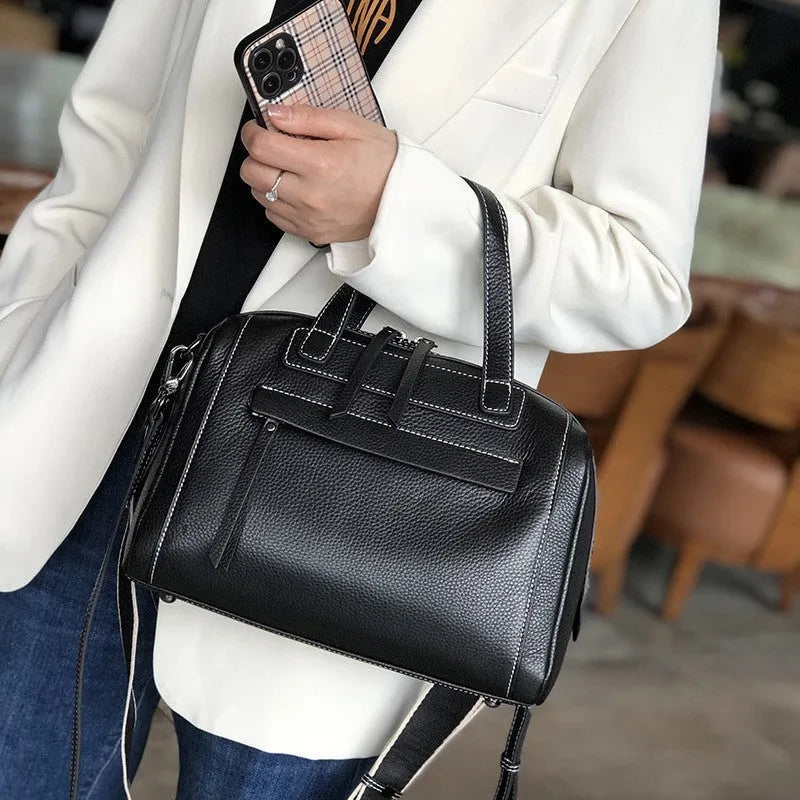 Genuine leather messenger bag with litchi pattern texture in a horizontal square shape.