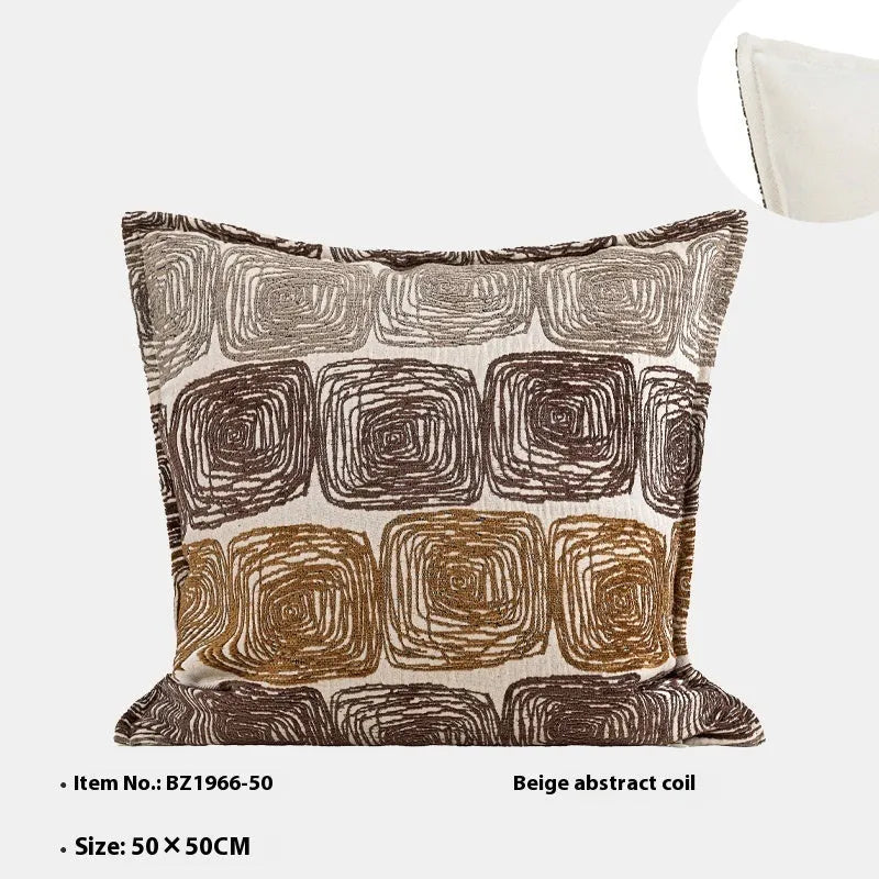 Cream and coffee coloured abstract coil pattern on a square decorative pillow cover.