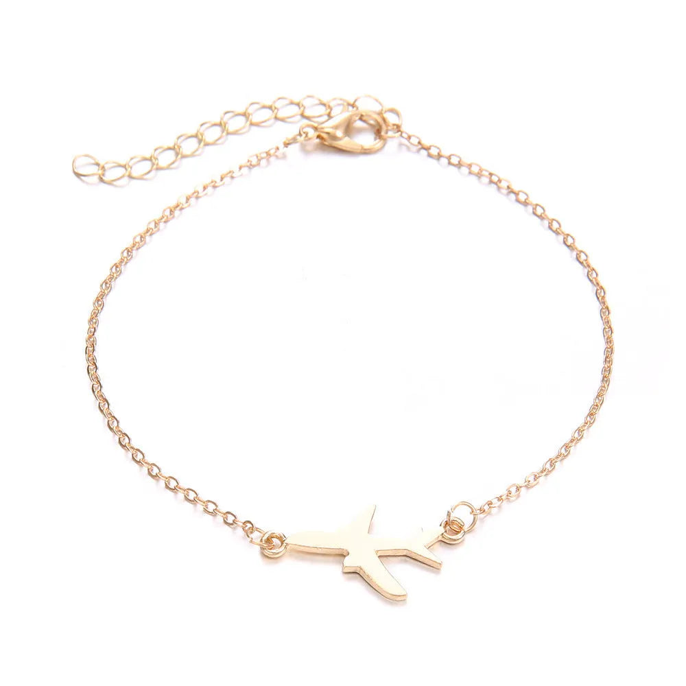 Three Bohemian-style bracelets with aircraft map and heart charms in gold electroplated finish