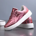 Rose gold and gold sequinned platform sneakers with round toe and thick MD sole.
