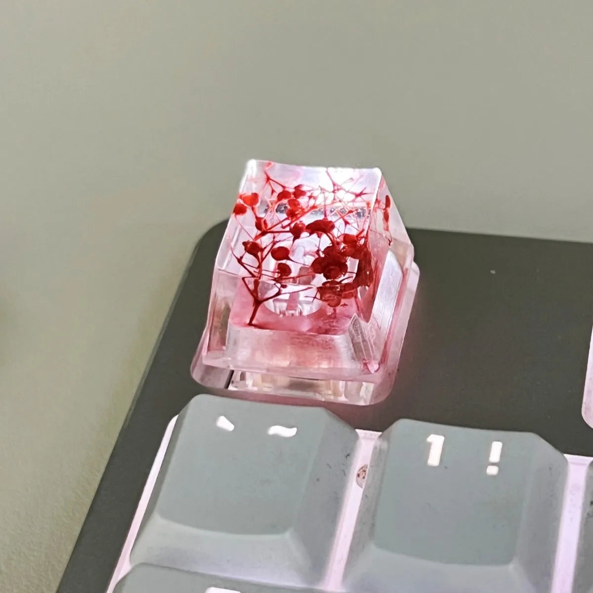Clear resin mechanical keyboard keycap with starry sky design in green.