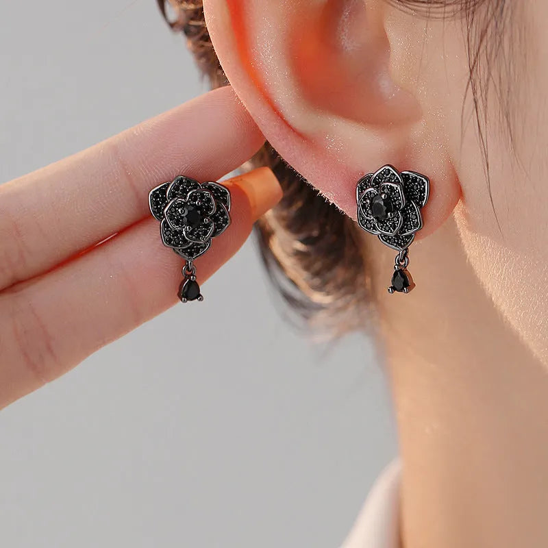 Pair of women's black rose zircon floral stud earrings on electroplated 18K copper.