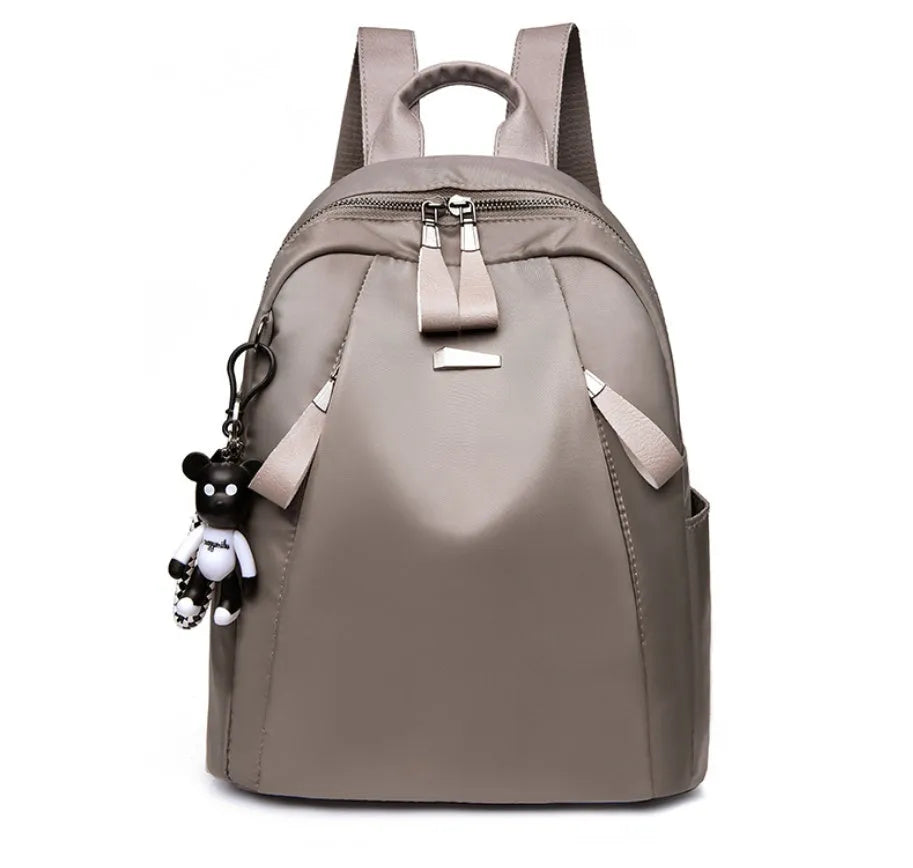 Medium grey Oxford cloth rucksack with double shoulder straps and front digging pocket.