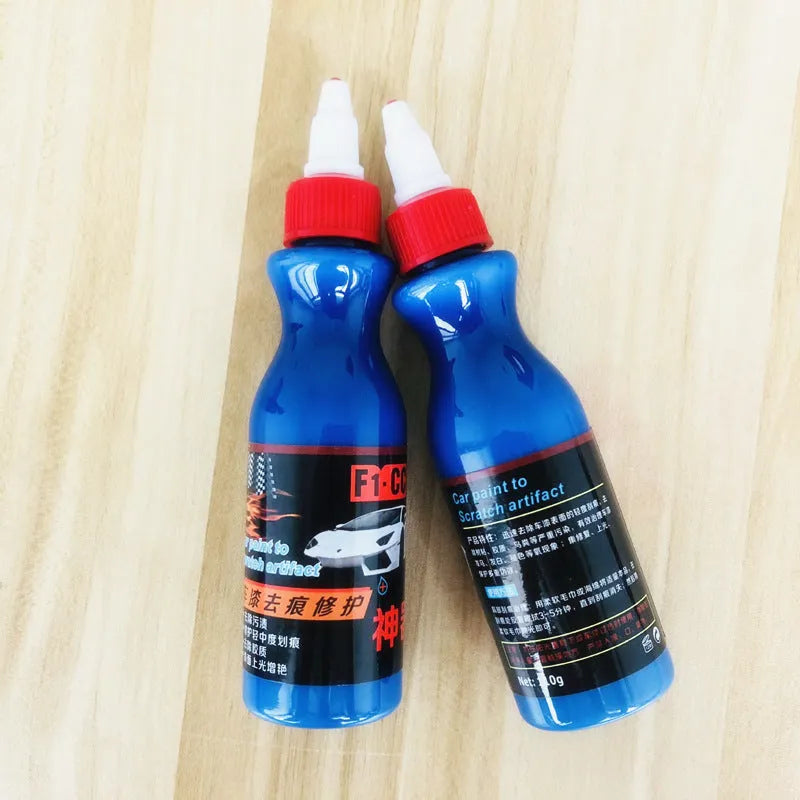 Small blue wiping tool and bottle of automobile scratch repair agent for minor vehicle surface imperfections