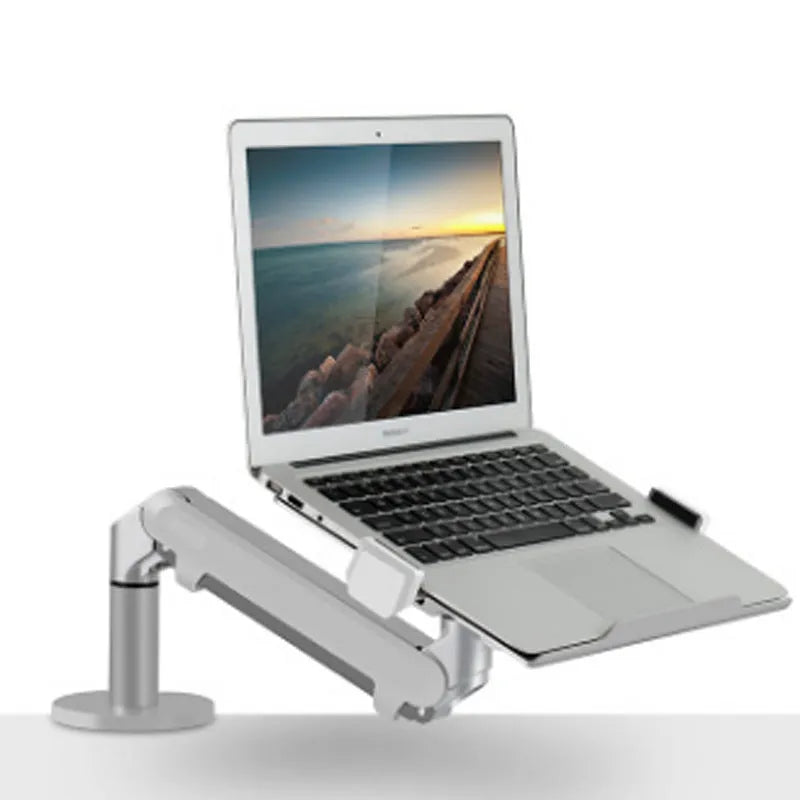 Black aluminium Free Hover adjustable laptop stand mounted on a desk edge, holding a silver notebook.