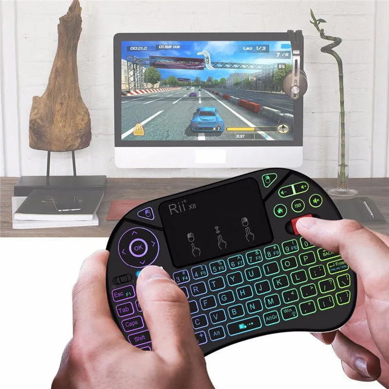 i8X black wireless keypad with QWERTY keyboard, touchpad, dual mouse buttons, USB adapter, and lithium battery