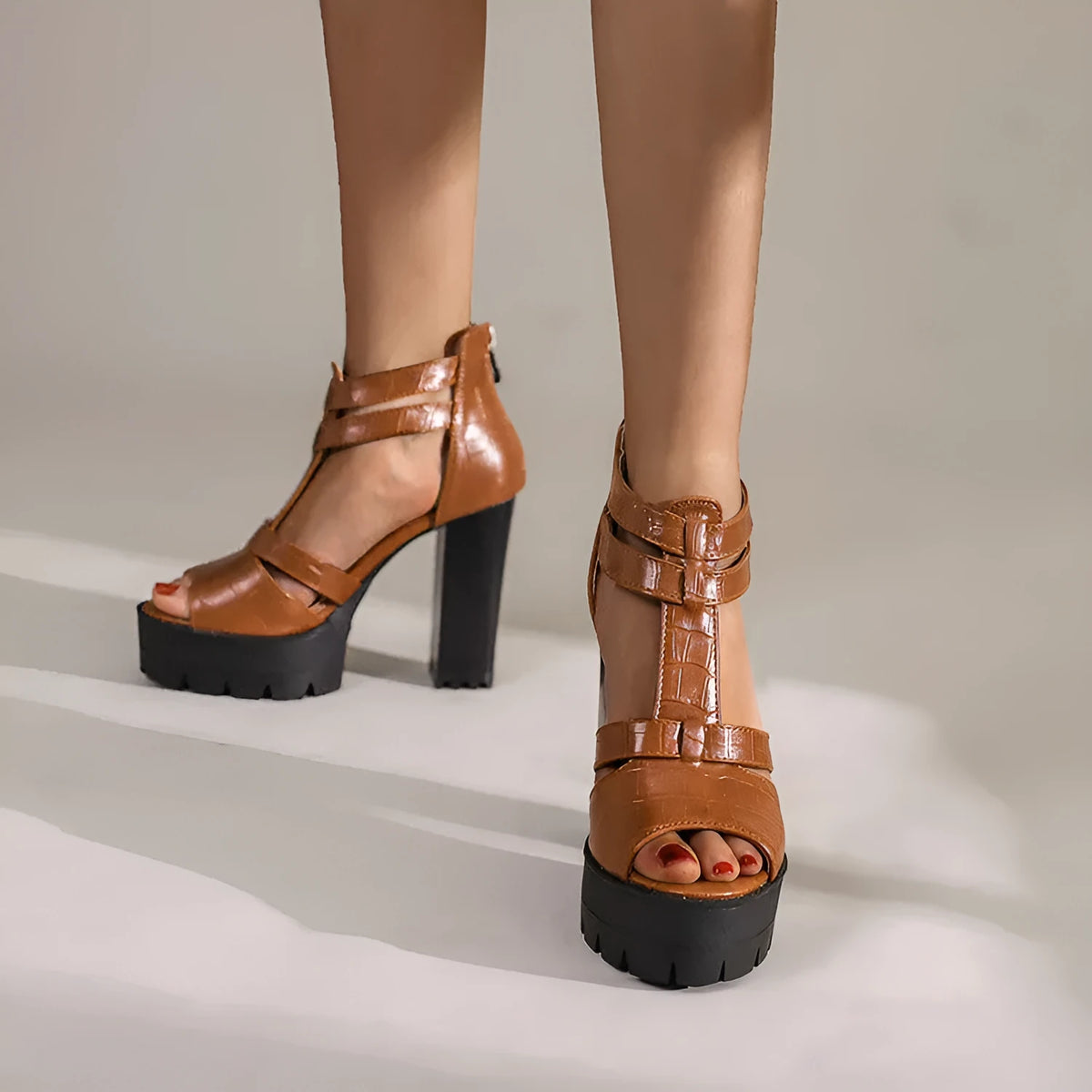 Women's black platform high heel sandals with a back zipper and round toe.