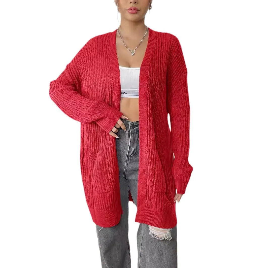 Women's dark green double pocket acrylic cardigan with long sleeves on a hanger.